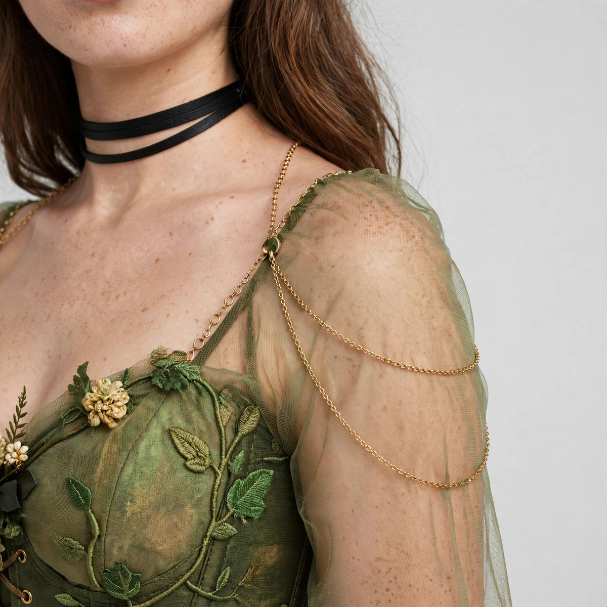 Close-up of the chiffon sleeve, choker and shoulder chain