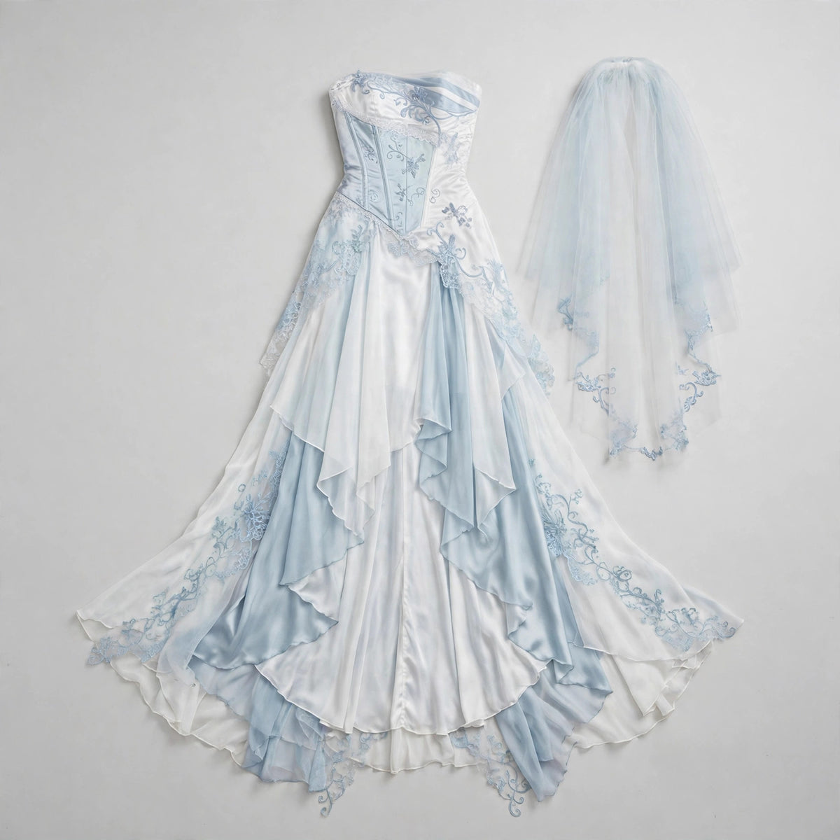 Flat lay of the dress, tail skirt and veil