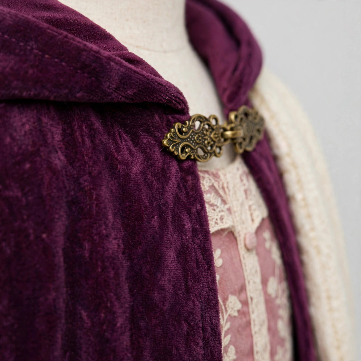 Close-up of the cloak clasp and hood fabric